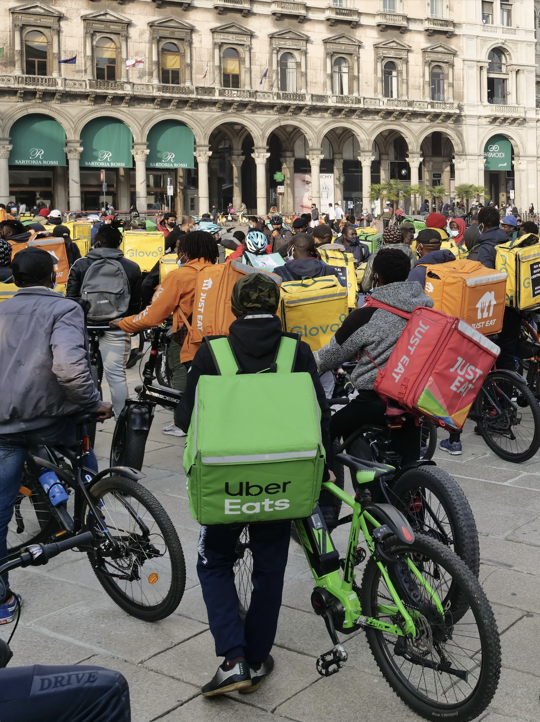 Food delivery riders assemble in a public square