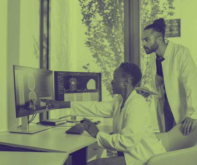 Two doctors looking at a computer screen
